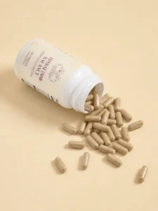 Thyrafemme Balance thyroid support supplement for women: open bottle of 60 capsules spilling onto a cream background