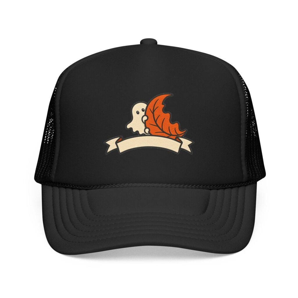Black foam trucker hat with a patch of a little ghost peeking out from behind an orange maple leaf above a cream banner