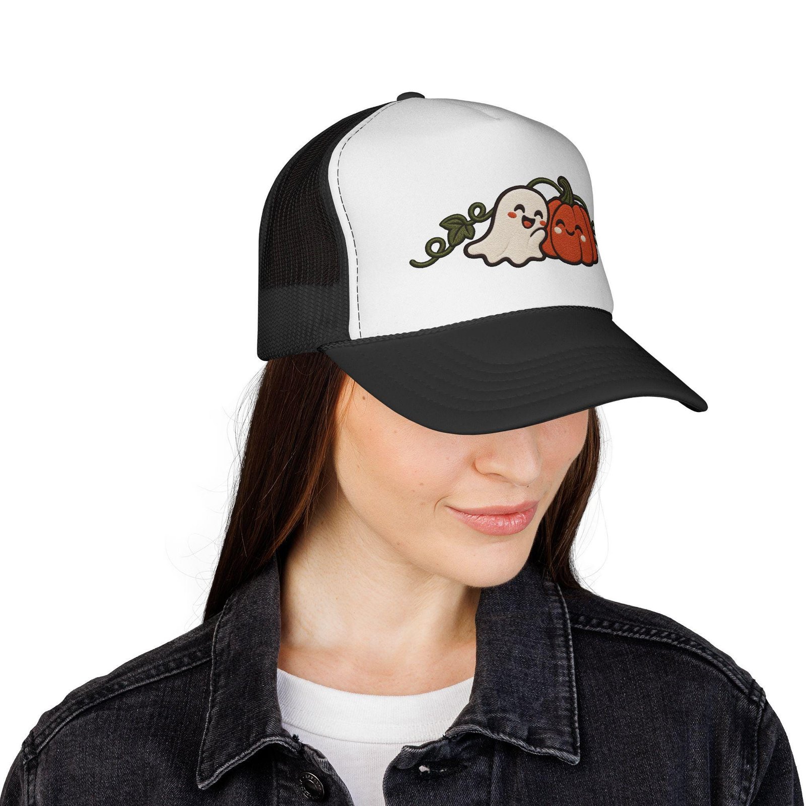 Woman in a denim jacket wearing the white and black ghost pumpkin trucker hat